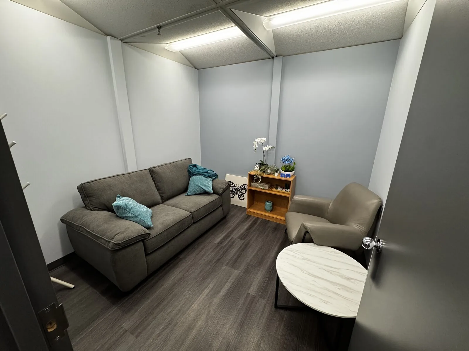 A warm counselling room at the Flutterby Psychology Calgary office
